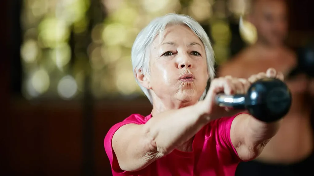 Toning Arms Without the Bulk: Is It Achievable? 1 Woman doing resistance band exercises for toned arms Bedfordshire